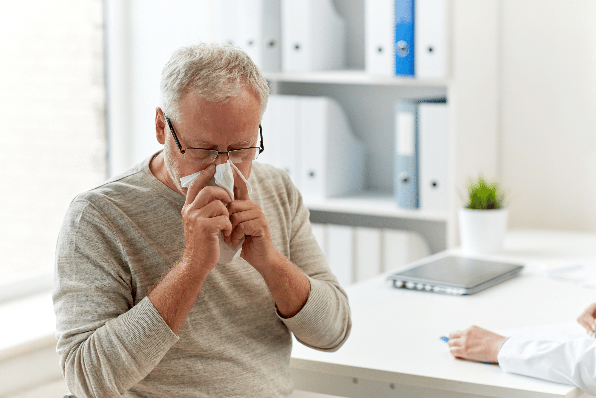 man blowing his nose