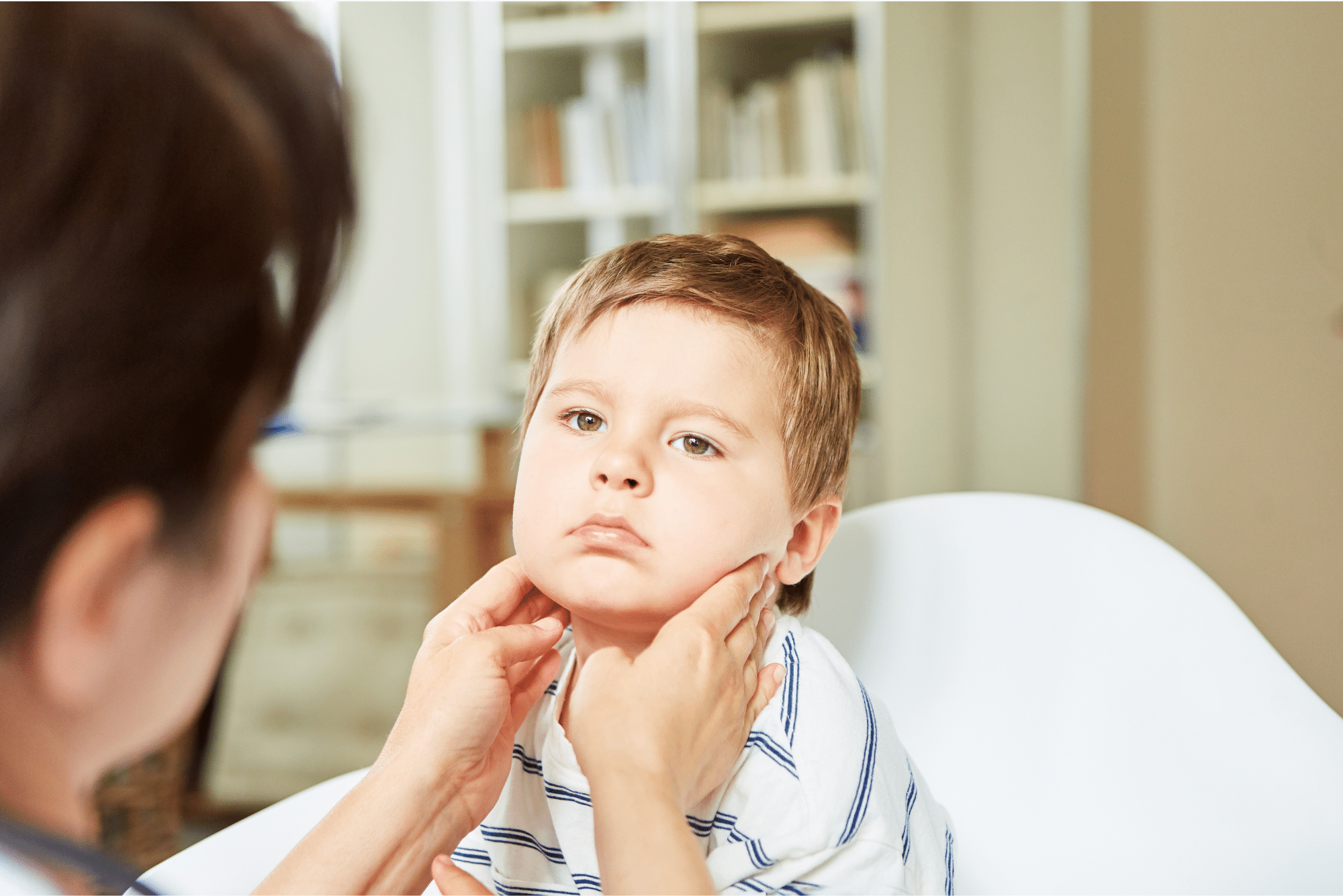 Doctor checking tonsils because child won't drink after tonsillectomy