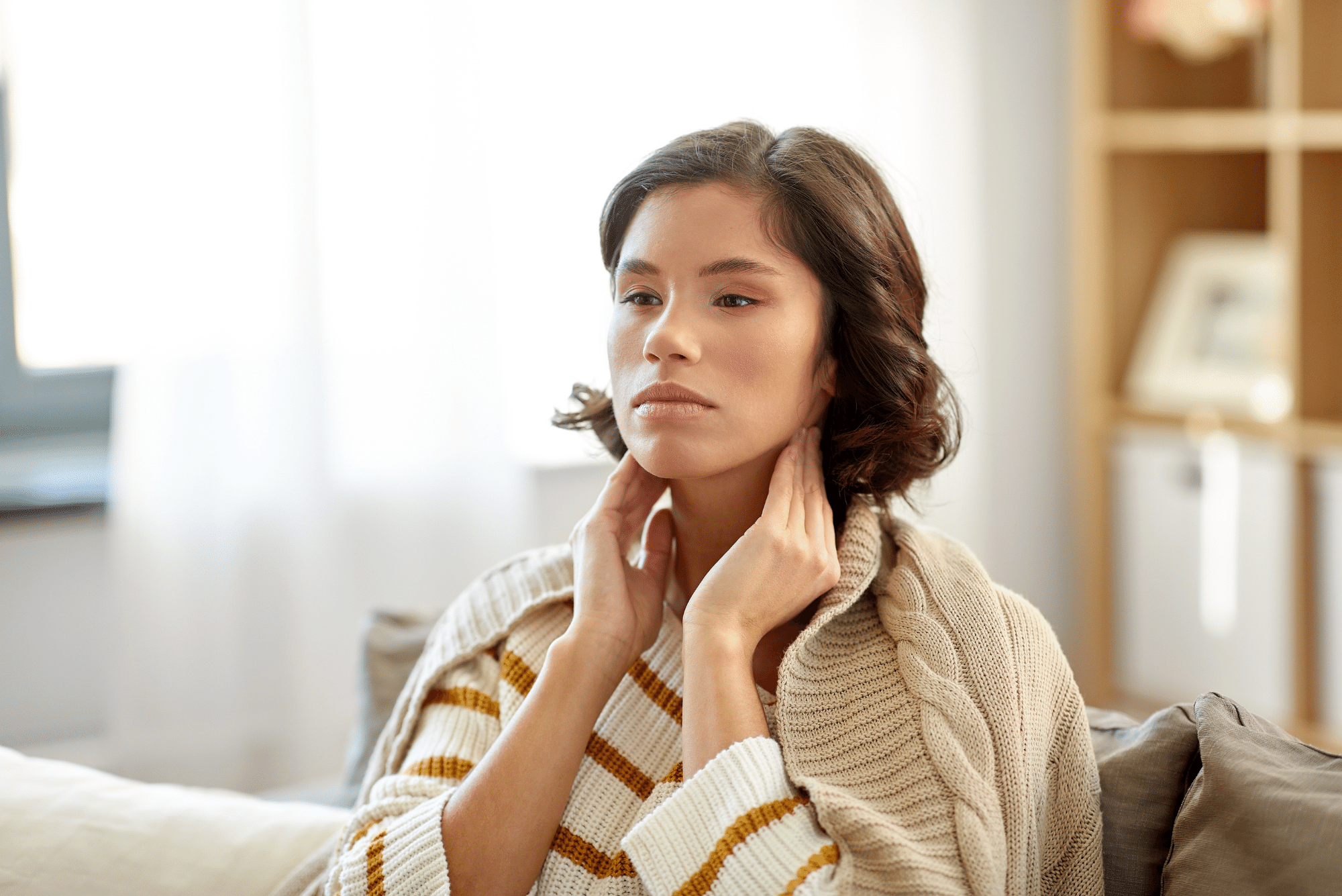 woman touching her neck