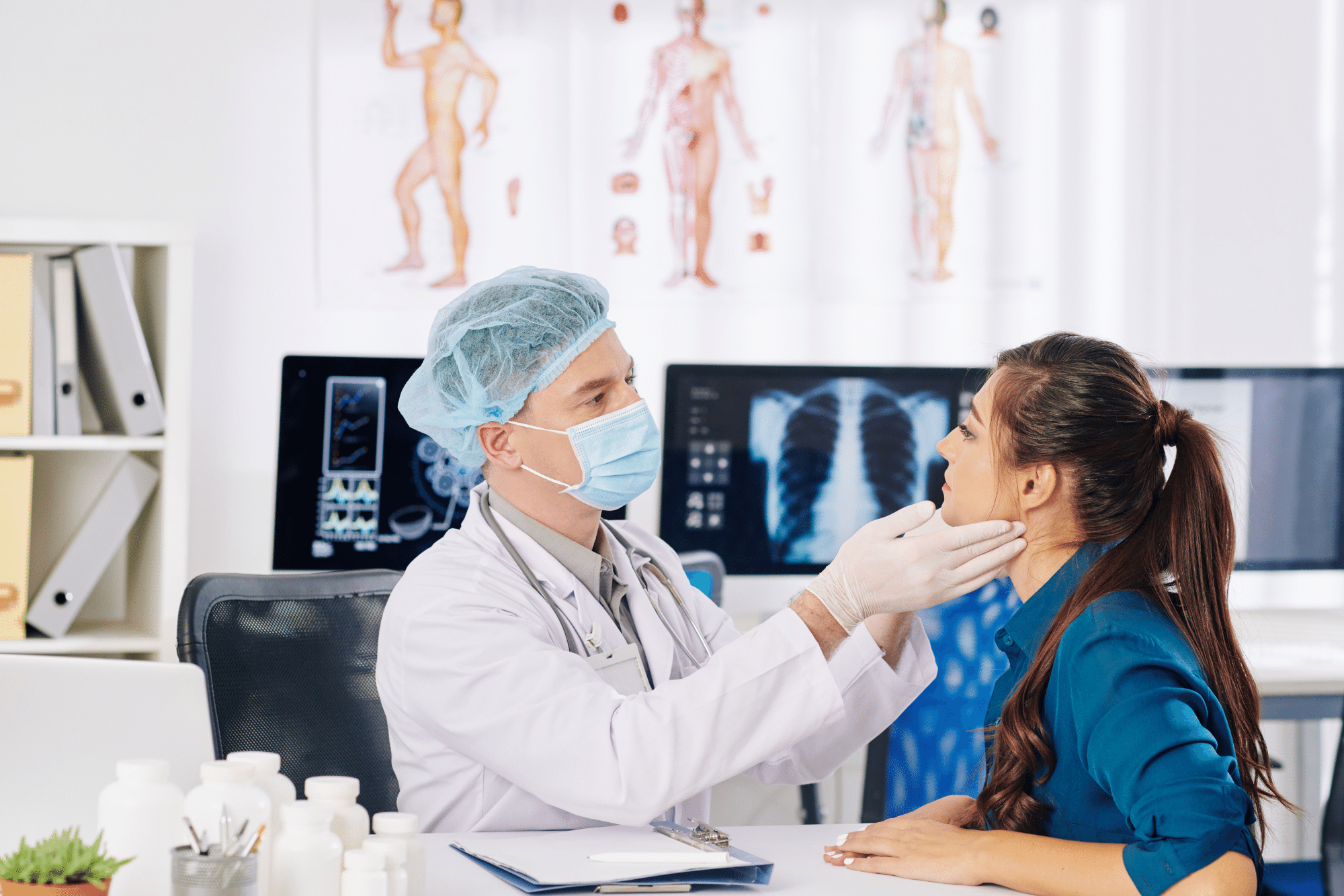 A physician in his office checks a female patient for salivary gland tumor symptoms.