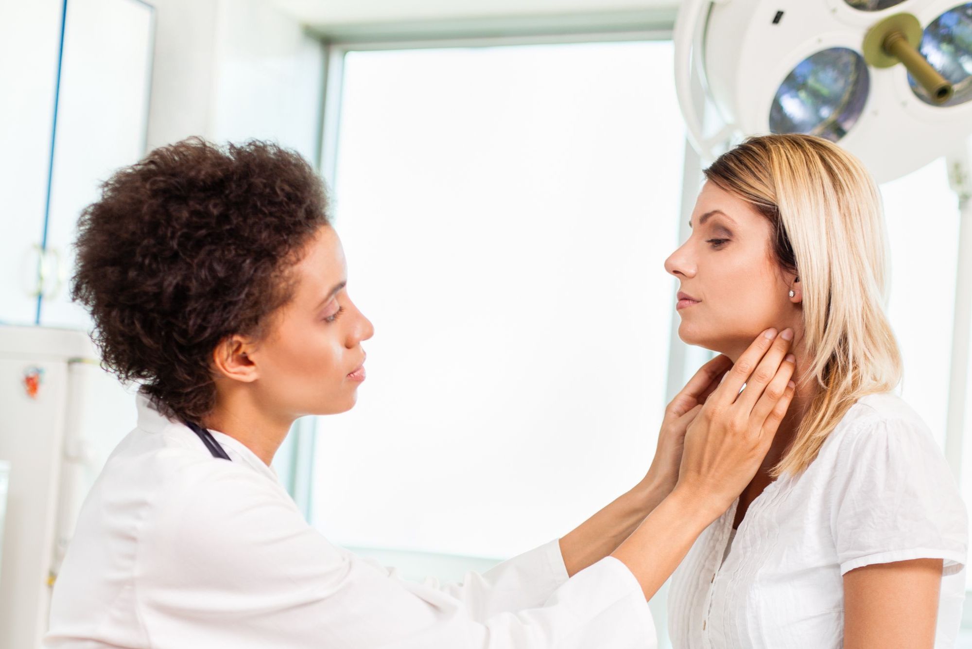 A physician examines a patient's thyroid to see what type of thyroidectomy she needs.