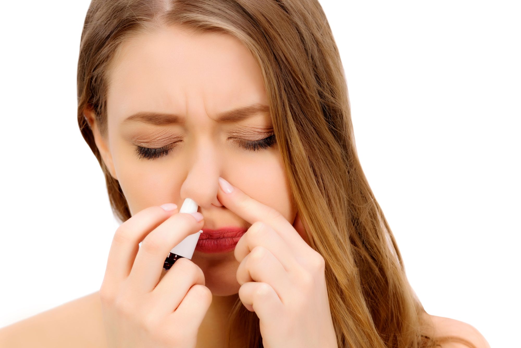 A woman tries a nasal polyps treatment spray.