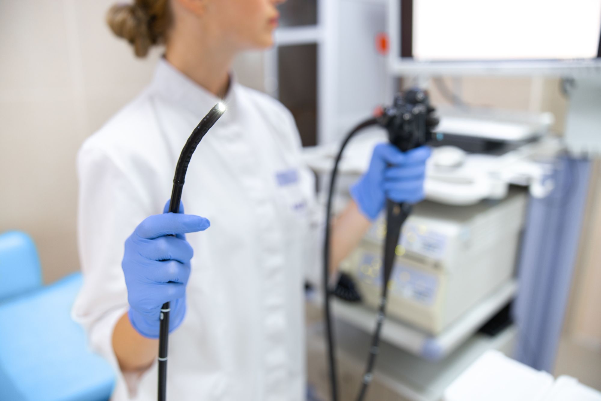 A physician holding equipment to begin a nasal endoscopy.