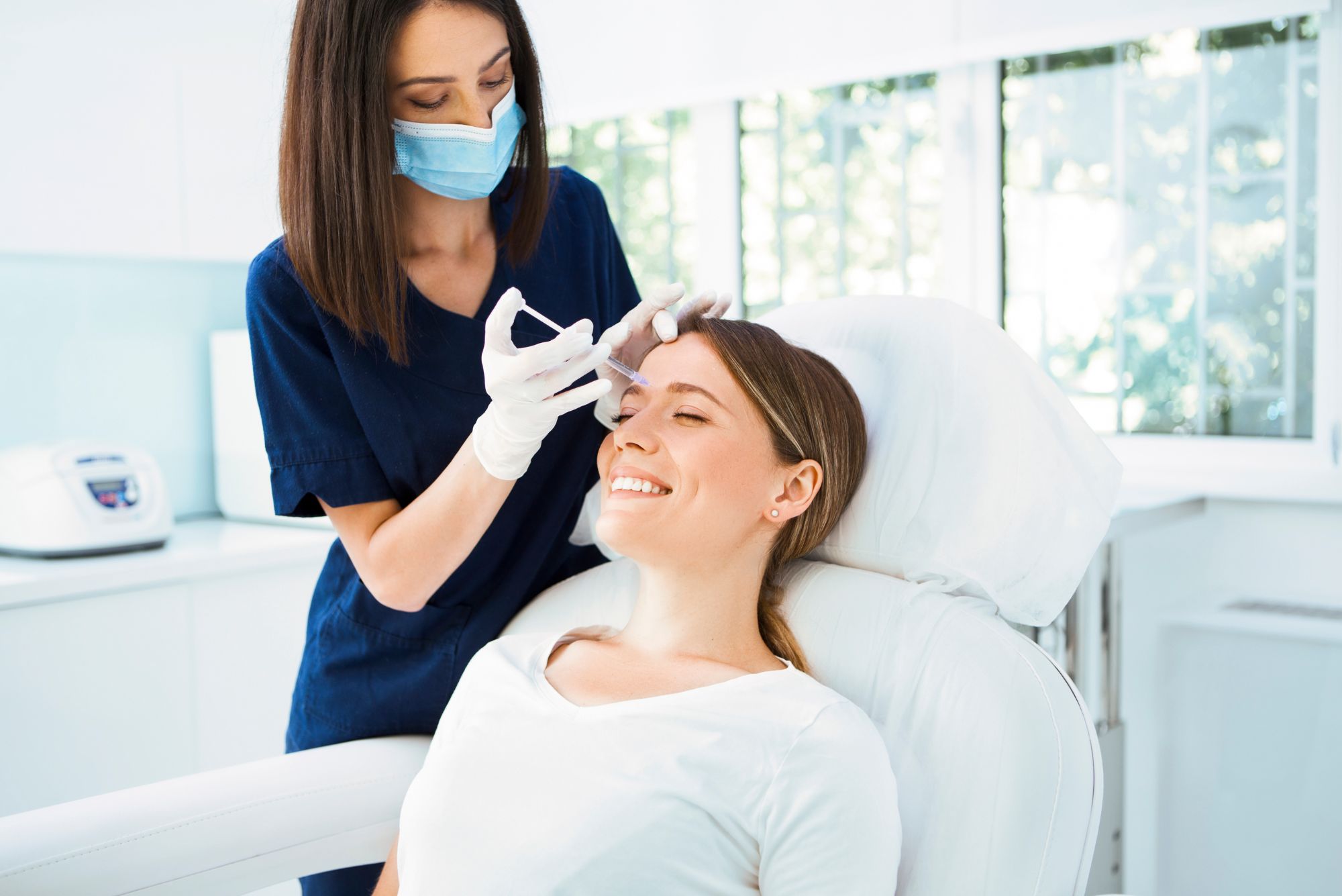 A young woman receives botox from her doctor after reading about the benefits of botox.