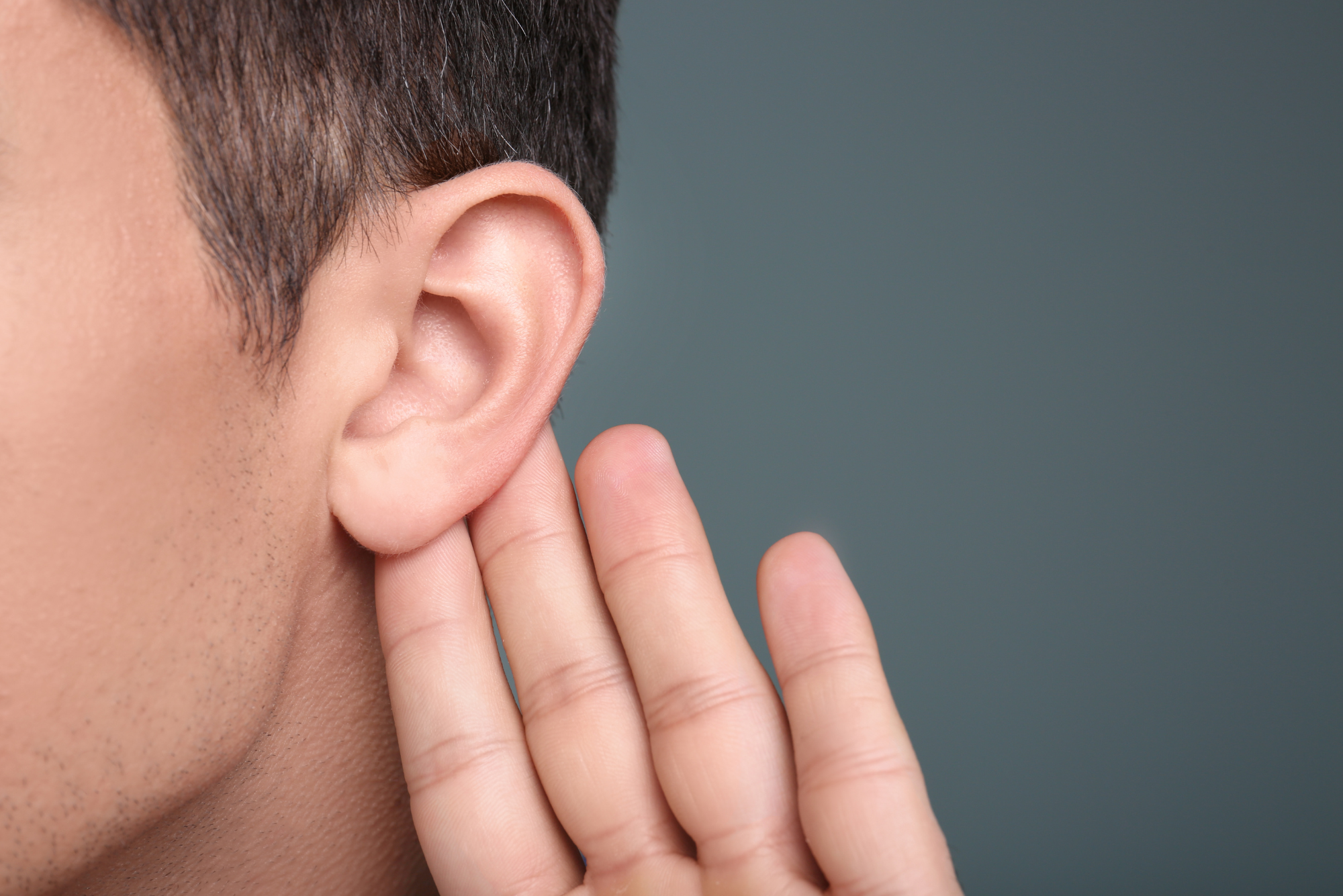 A close-up shot of a patient’s ear that has a ruptured eardrum representing paper patch vs. myringoplasty procedures.