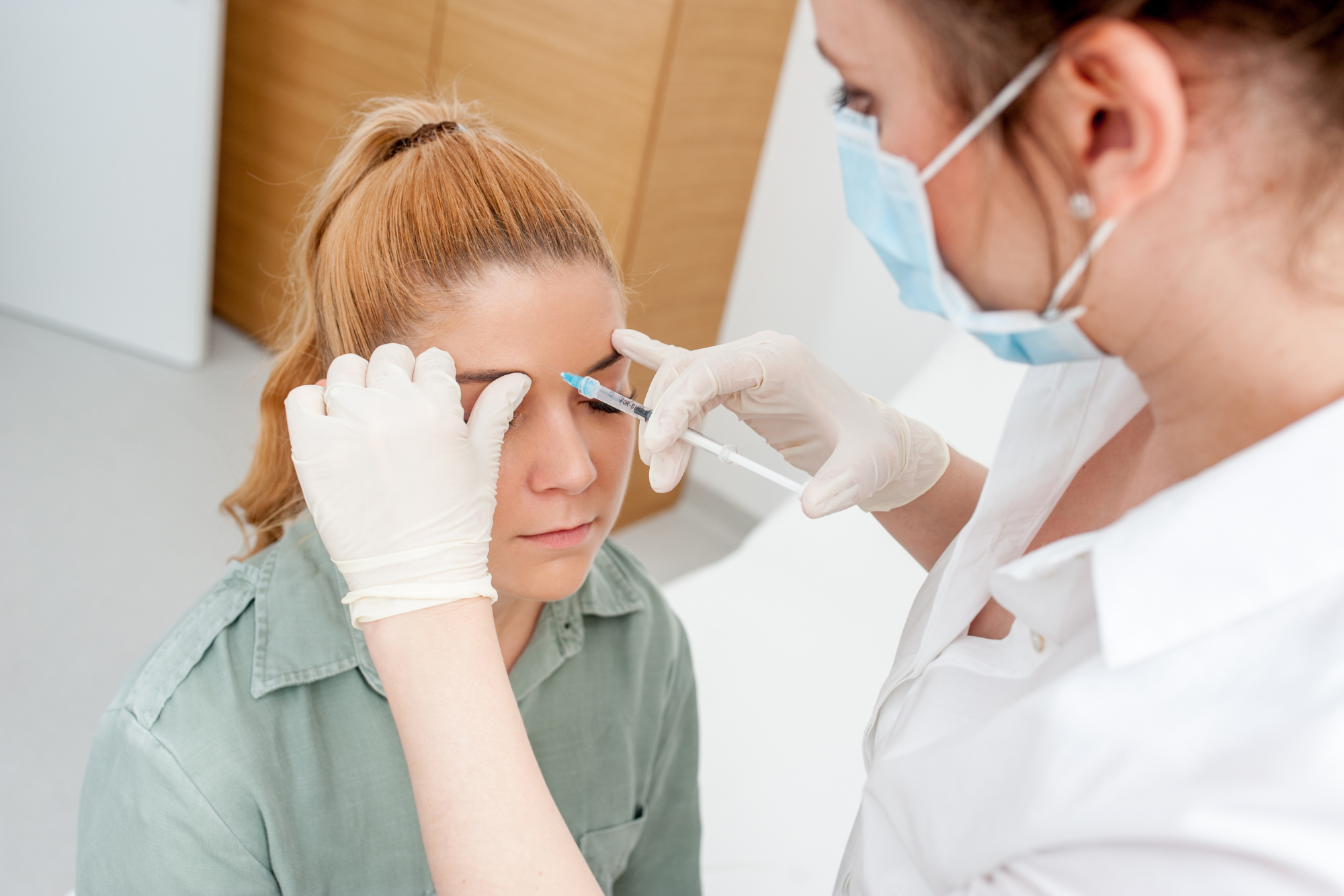 A girl gets an eyebrow lift with botox to combat the look of aging.